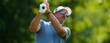 Phil Mickelson wears shades as he watches the ball after teeing off. Phil Mickelson wears shades as he watches the ball after teeing off.