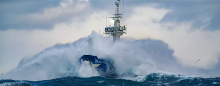 a fishing ship crashing through large waves at sea a fishing ship crashing through large waves at sea
