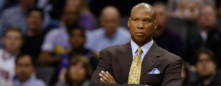 Byron Scott wears a suit and tie and has his arms crossed on the sidelines 