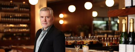 Restaurant critic Bill Addison stands at a bar.