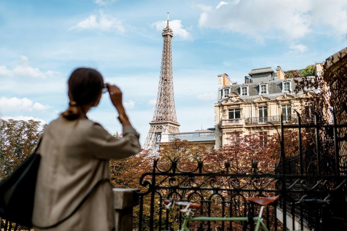 Woman looking at the Eiffel Tower from her balcony